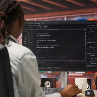 programmer-types-code-into-pc-entering-commands-running-script 1